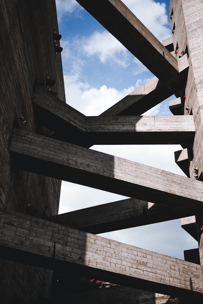 creative-03 Abstract perspective of intersecting concrete beams against blue sky.